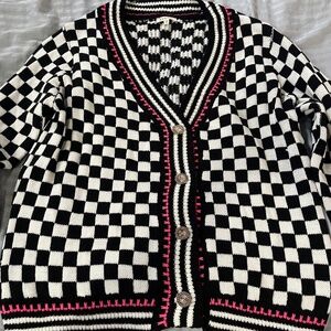 Black and white checkered cardigan sweater with pink border